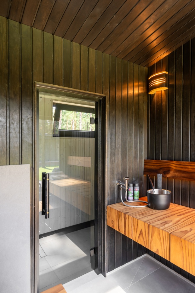 Insulated sauna house with a burnt wood  cladding