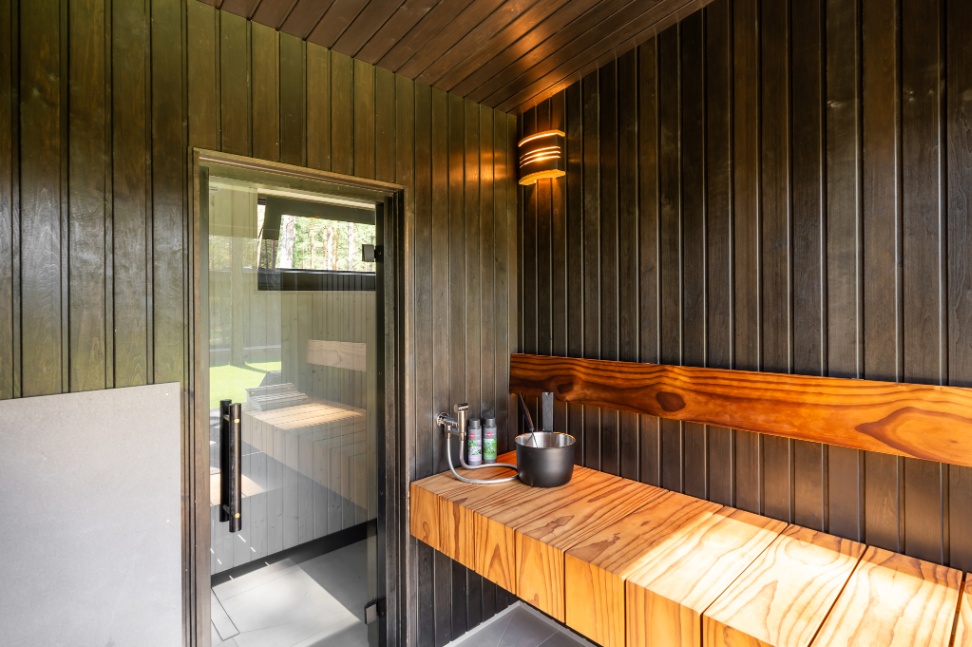 Insulated sauna house with a burnt wood  cladding