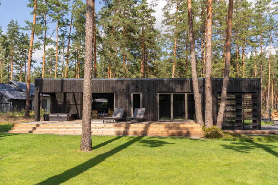 Insulated sauna house with a burnt wood  cladding