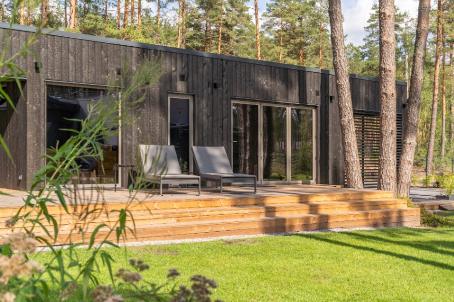 Insulated sauna house with a burnt wood  cladding