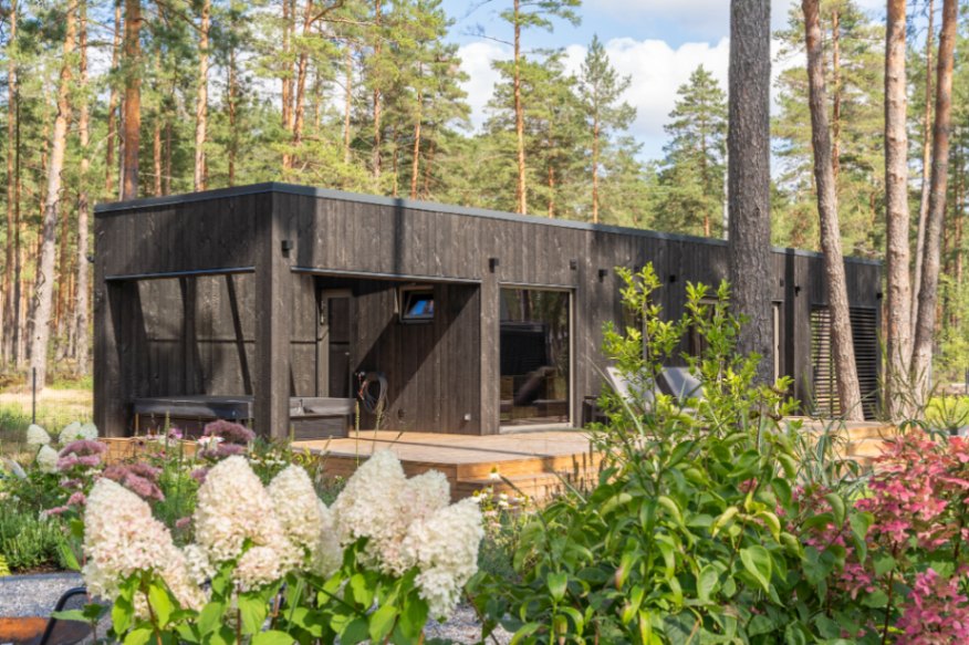 Insulated sauna house with a burnt wood  cladding