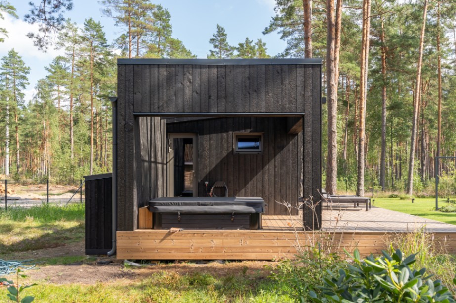 Insulated sauna house with a burnt wood  cladding