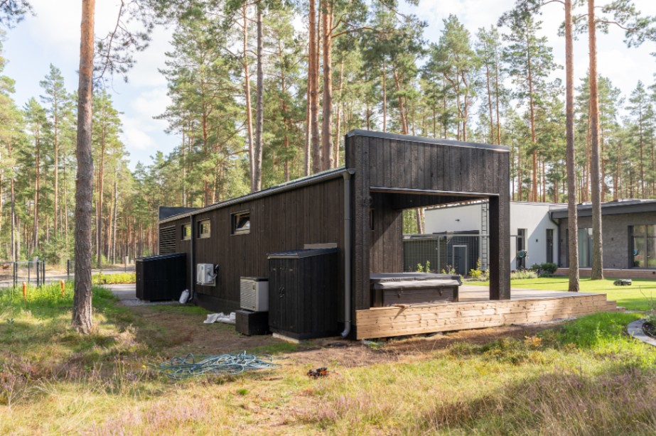 Insulated sauna house with a burnt wood  cladding