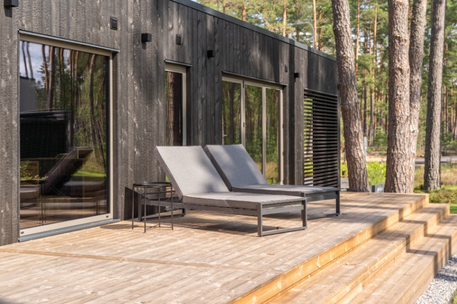 Insulated sauna house with a burnt wood  cladding