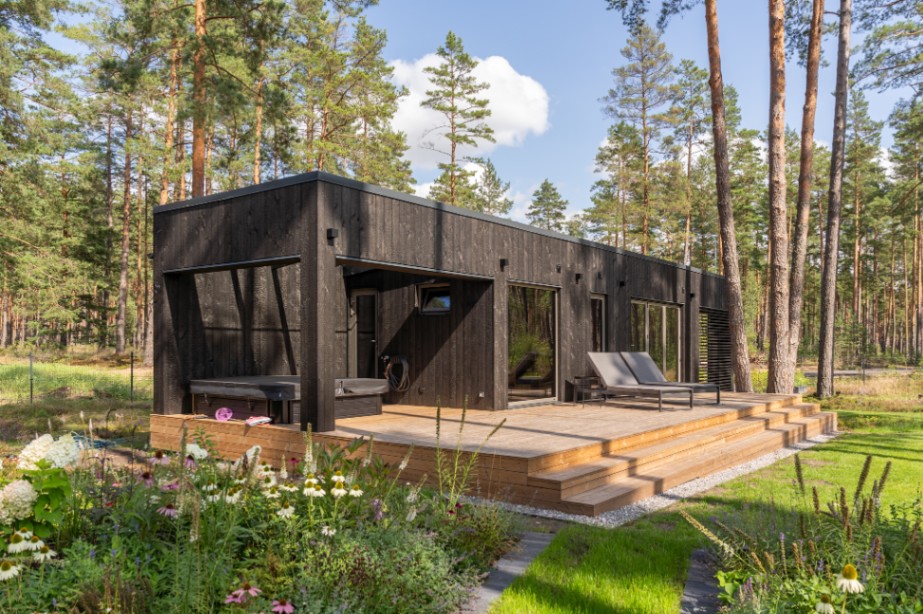 Insulated sauna house with a burnt wood  cladding