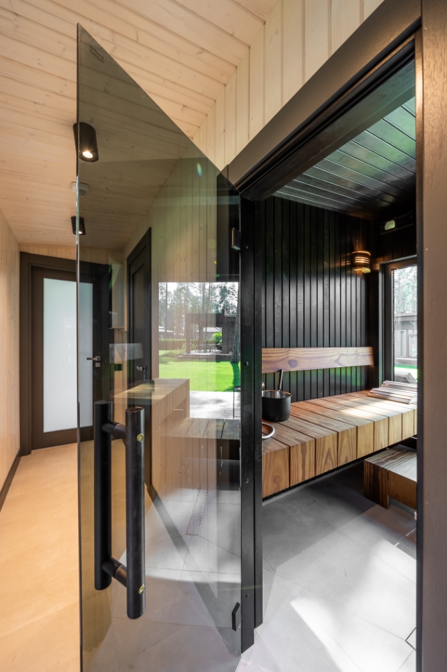 Insulated sauna house with a burnt wood  cladding