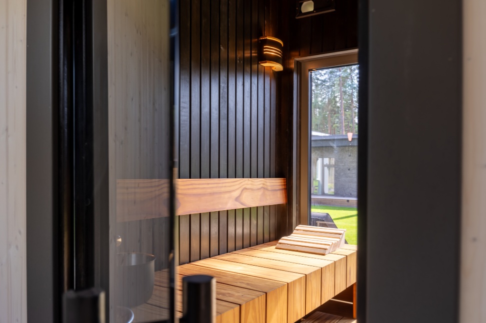Insulated sauna house with a burnt wood  cladding